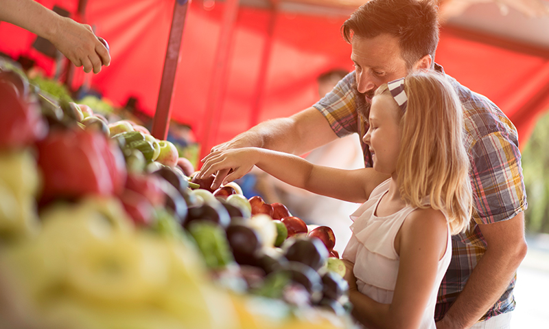 Father and daughter at farmers market